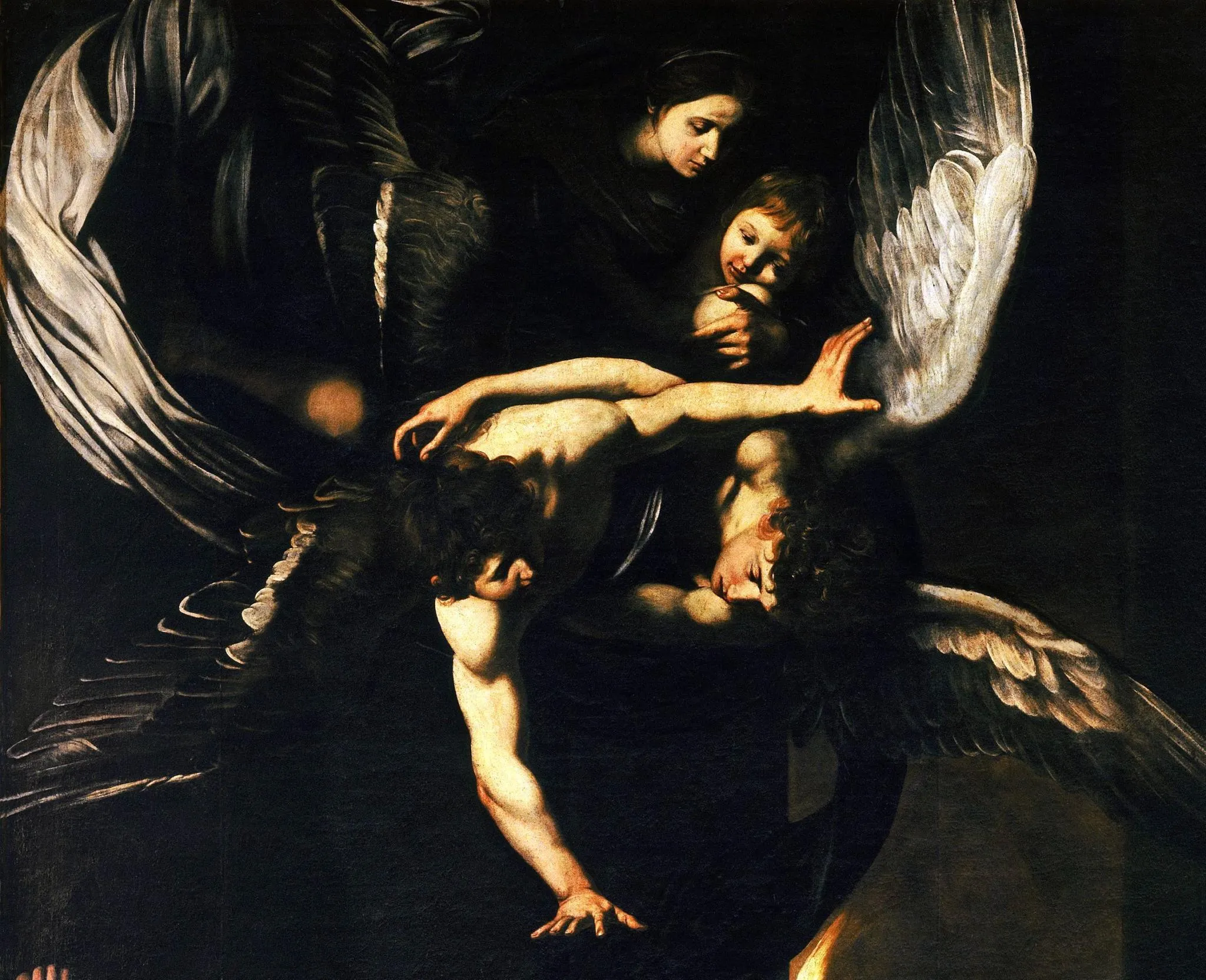 Particolare delle Sette opere di misericordia di Caravaggio: la Madonna con il Bambino e due angeli illuminati emergono dal buio.